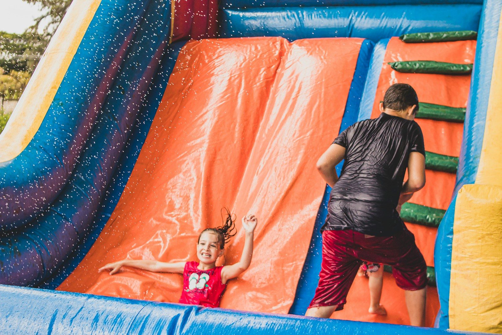 a little girl is playing in a bouncy castle